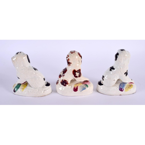 33 - THREE 19TH CENTURY STAFFORDSHIRE POTTERY FIGURES OF SPANIELS. 12 cm x 8 cm. (3)