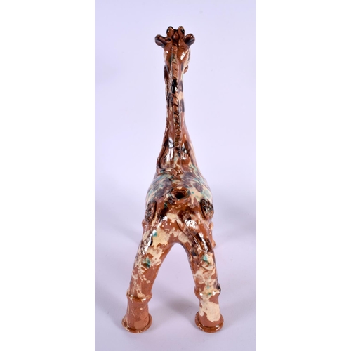 337 - A TURKISH CANAKKALE POTTERY FIGURE OF AN ANIMAL slip decorated with painted enamels. 30 cm x 14 cm.