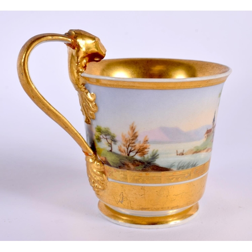 34 - A 19TH CENTURY AUSTRIAN VIENNA PORCELAIN CUP AND SAUCER painted with landscapes. 13 cm diameter.