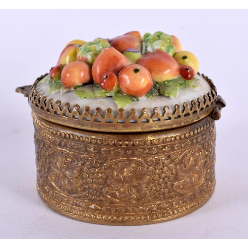 349 - A CONTINENTAL PORCELAIN GILT METAL FRUIT PILL BOX. 7 cm wide.