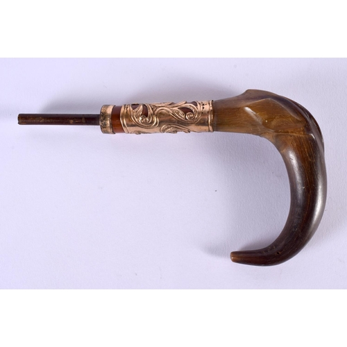 353 - AN ANTIQUE CARVED RHINOCEROS HORN CANE HANDLE with yellow metal mounts. 20 cm x 10 cm.