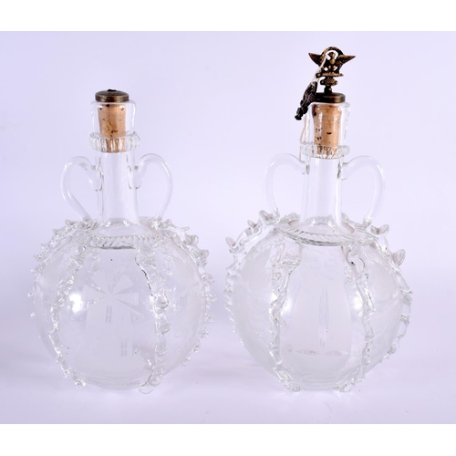 36 - A PAIR OF ANTIQUE GLASS DECANTERS AND STOPPERS decorated with boats and foliage. 25 cm x 12 cm.