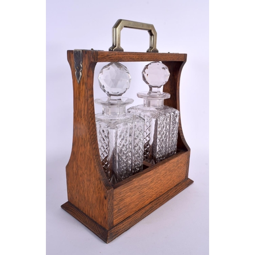 360 - AN ANTIQUE OAK TWIN BOTTLE GLASS TANTALUS. 34 cm x 20 cm.