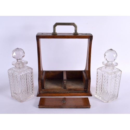 360 - AN ANTIQUE OAK TWIN BOTTLE GLASS TANTALUS. 34 cm x 20 cm.