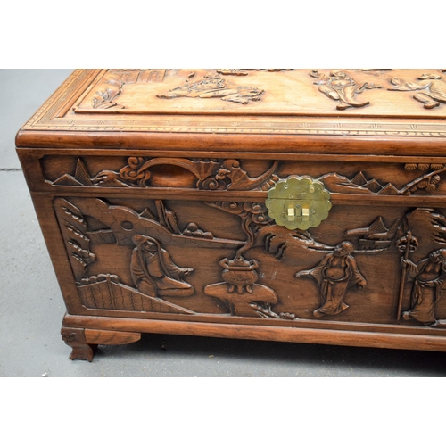 363 - A LARGE 19TH CENTURY CHINESE CARVED HARDWOOD COFFER Qing, carved with figures in landscapes. 90 cm x... 