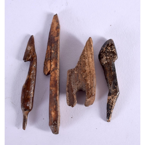 366 - FOUR ANTIQUE NORTH AMERICAN PETRIFIED FOSSILISED BONE HARPOON HEADS. Largest 8 cm long. (4)