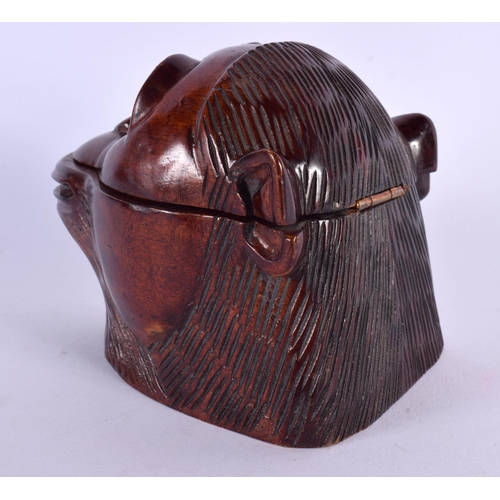 376 - A NOVELTY VICTORIAN CARVED FRUITWOOD INKWELL modelled as a monkey with glass eyes. 11 cm x 8 cm.