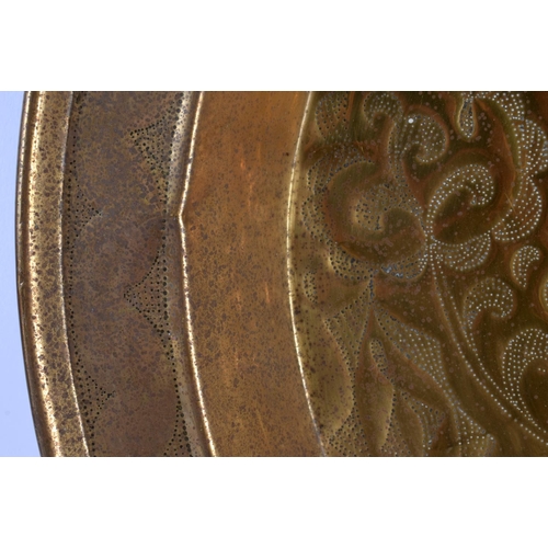 381 - A 19TH CENTURY CONTINENTAL BRASS PUNCH WORK CHARGER decorated with foliage. 42 cm diameter.