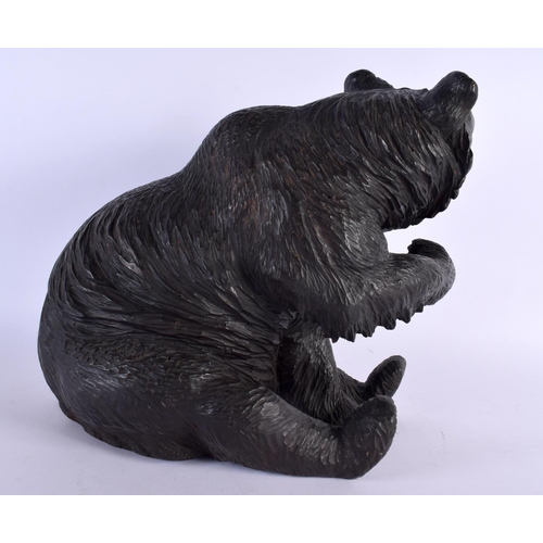 383 - A 19TH CENTURY BAVARIAN BLACK FOREST FIGURE OF A BEAR modelled seated with arm raised. 30 cm x 24 cm... 