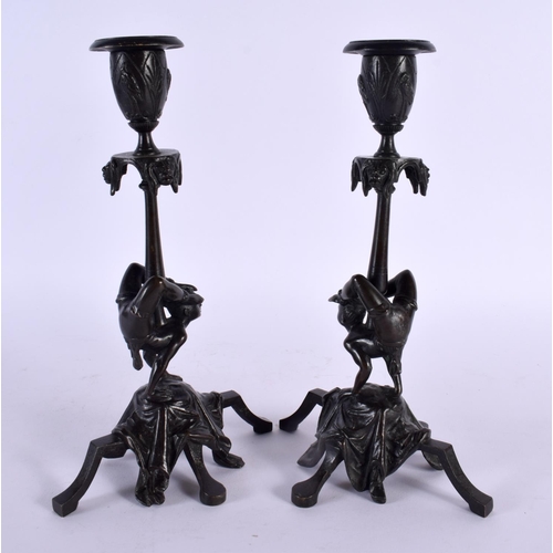 389 - A RARE PAIR OF 19TH CENTURY EUROPEAN BRONZE CANDLESTICKS formed as acrobats. 22.5 cm high.