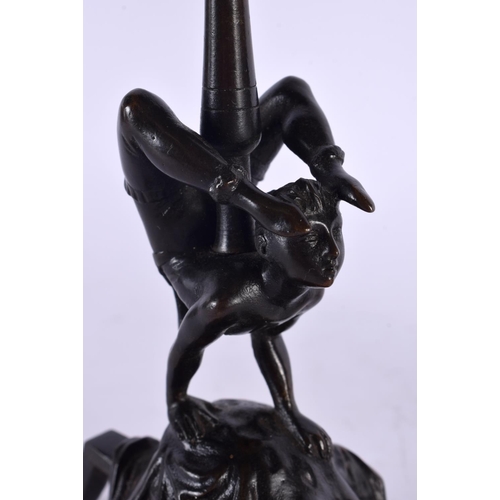 389 - A RARE PAIR OF 19TH CENTURY EUROPEAN BRONZE CANDLESTICKS formed as acrobats. 22.5 cm high.