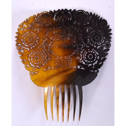 400 - A LARGE ART DECO CARVED TORTOISESHELL COMB formed with an urn amongst foliage. 15 cm x 18 cm.