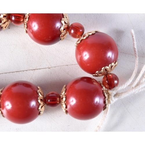 1031 - A CHERRY AMBER TYPE RED BEAD BRACELET. 26 grams. 5.25 cm wide.