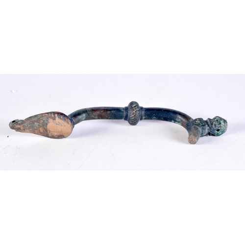 1051 - AN EARLY MIDDLE EASTERN BRONZE HANDLE. 19 cm x 5.5 cm.