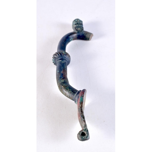 1051 - AN EARLY MIDDLE EASTERN BRONZE HANDLE. 19 cm x 5.5 cm.