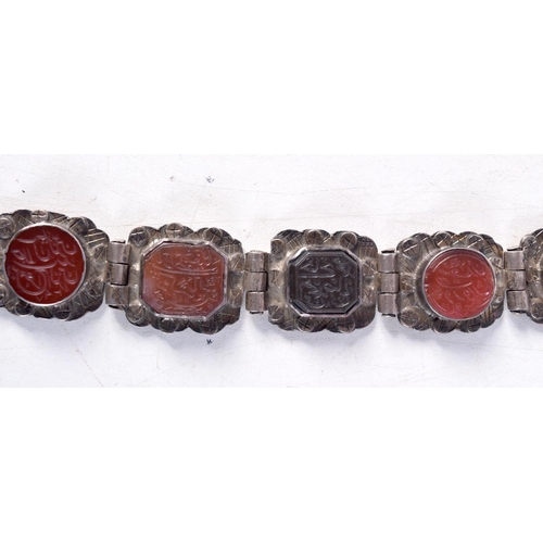 1130 - AN ANTIQUE MIDDLE EASTERN WHITE METAL AND AGATE BRACELET. 59.2 grams. 17 cm long.