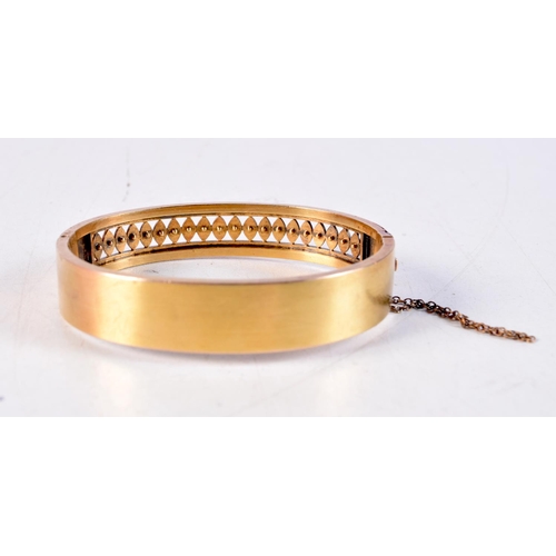 1166 - A VICTORIAN 15CT GOLD AND SEED PEARL BANGLE. 14.9 grams. 5.5 cm x 4.5 cm.