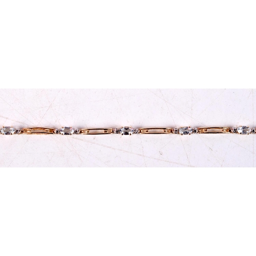 1169 - A 14CT GOLD AND AQUAMARINE BRACELET. 4 grams. 17.5 cm long.