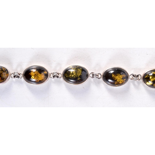 1239 - A SILVER AND AMBER BRACELET. 18.5 grams. 20 cm long.