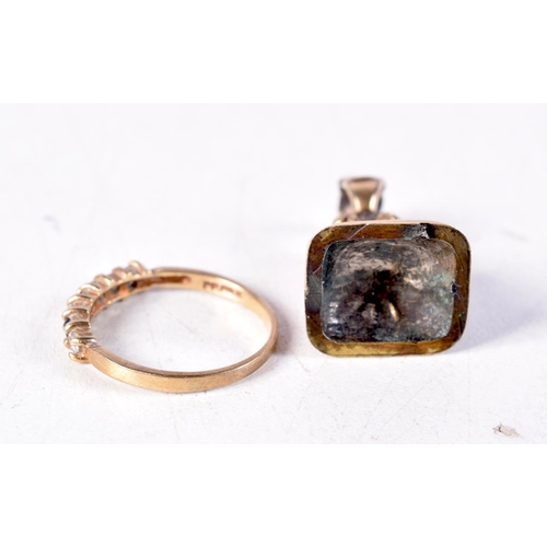 1290 - A 9CT GOLD RING and a seal. Ring J. 5 grams. (2)