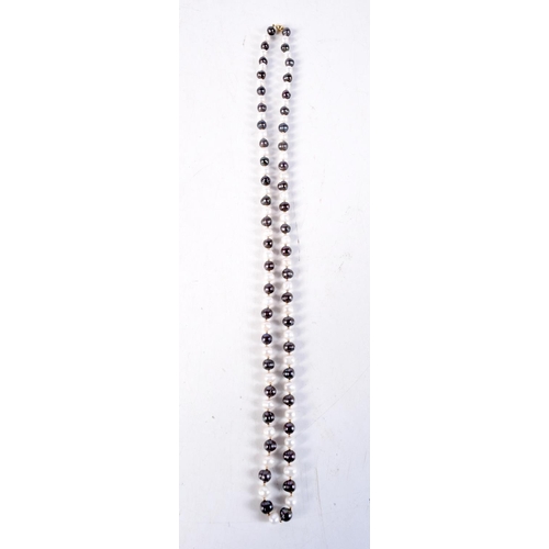 1315 - A 14CT GOLD MIKIMOTO PEARL NECKLACE. 61.8 grams. 87 cm long.