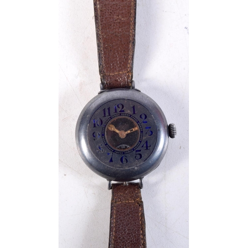 1373 - AN ANTIQUE SILVER AND ENAMEL TRENCH TYPE WATCH. 3.75 cm wide.