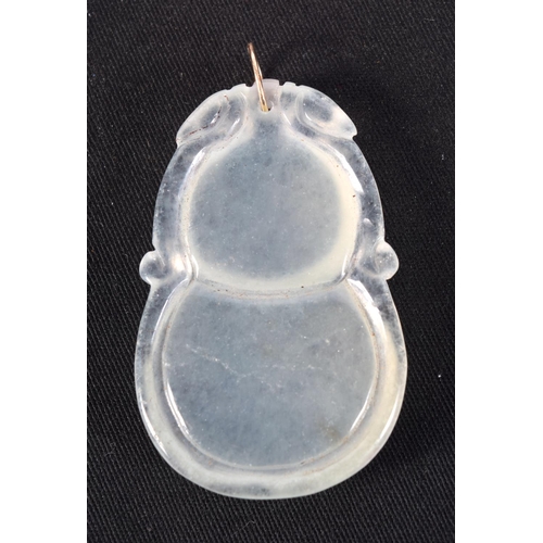 1417 - A GOLD TOPPED CHINESE ICEY JADE PENDANT. 20.5 grams. 5 cm x 3 cm.