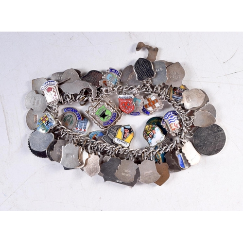 1441 - A SILVER CHARM BRACELET. 99 grams. 5.5 cm internal diameter.