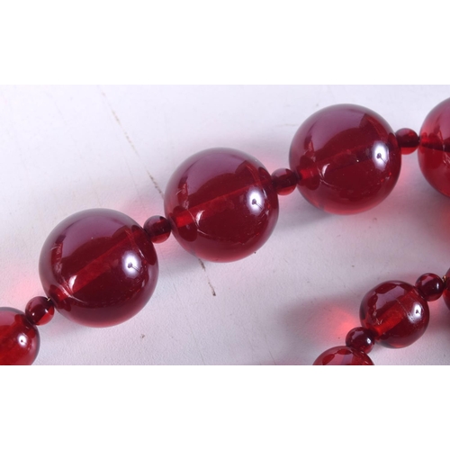 1466 - A CHERRY AMBER TYPE NECKLACE. 111 grams. 63 cm long.