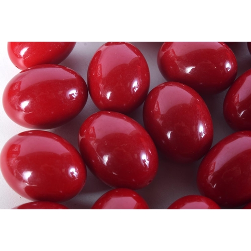 1477 - LARGE CHERRY AMBER TYPE BEADS. 630 grams. 3.75 cm x 3 cm. (qty)