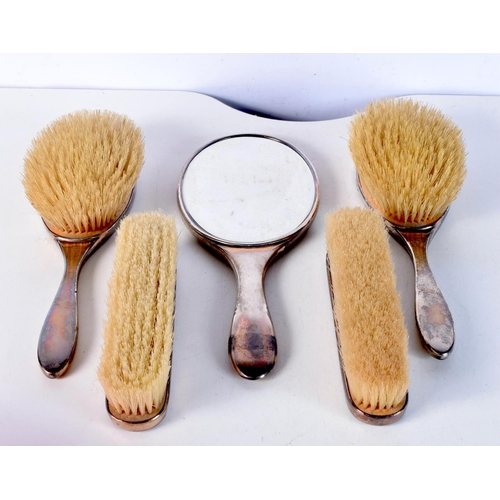 1675 - AN ART DECO SILVER AND TORTOISESHELL BRUSH SET. 800 grams overall. Largest 27 cm x 18 cm. (5)