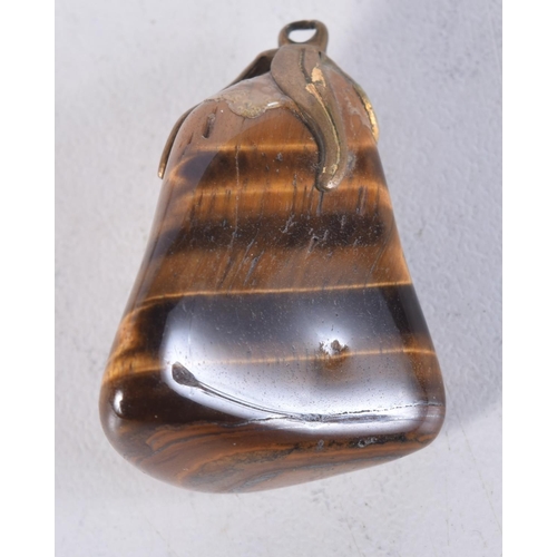 1700 - A CONTINENTAL CARVED TIGERS EYE PENDANT. 5 cm x 3 cm.