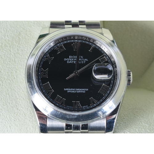 1704 - A ROLEX BLACK DIAL DATEJUST STAINLESS STEEL WRISTWATCH. 3.75 cm wide inc winder.