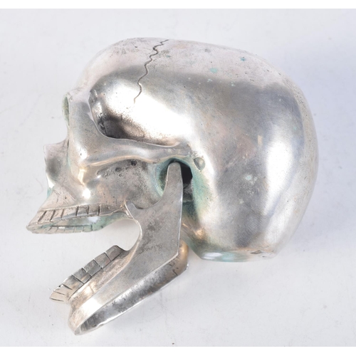 1708 - A SILVER PLATED SKULL. 12 cm x 9.5 cm.