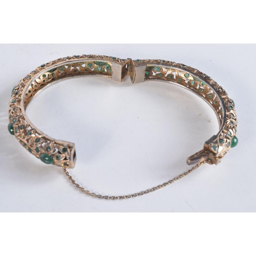 1745 - A CONTINENTAL YELLOW METAL EMERALD BRACELET. 38.4 grams. 6 cm wide.