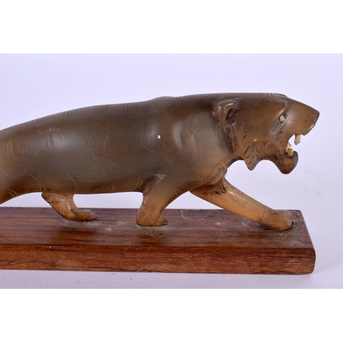 2019 - A 19TH CENTURY ANGLO INDIAN MIDDLE EASTERN CARVED RHINOCEROS HORN LION together with an unusual Indi... 