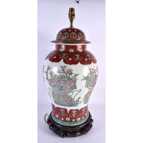 2039 - A LARGE CHINESE FAMILLE ROSE PORCELAIN LAMP 20th Century, painted with flowers. 60 cm x 22 cm.