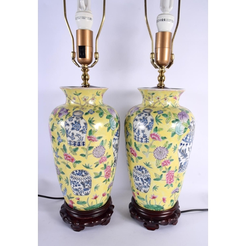 2041 - A PAIR OF CHINESE FAMILLE JAUNE PORCELAIN LAMPS 20th Century. 62 cm high.