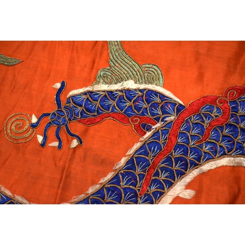 2054 - A PAIR OF 19TH CENTURY CHINESE ORANGE SILK EMBROIDERED DRAGON PANELS together with other similar sil... 