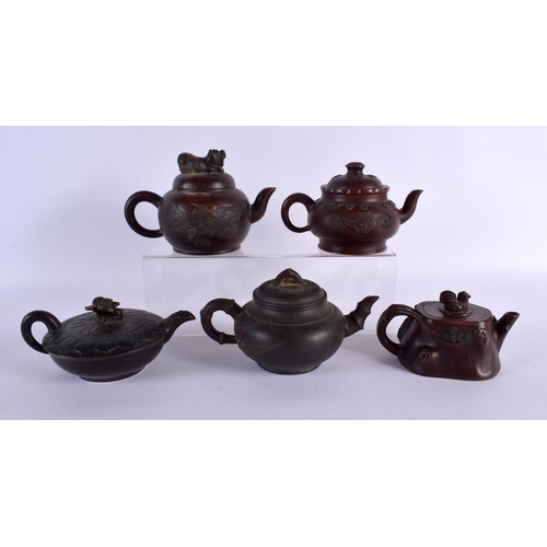 2069 - FIVE CHINESE YIXING POTTERY TEAPOT AND COVERS. Largest 15 cm wide. (5)