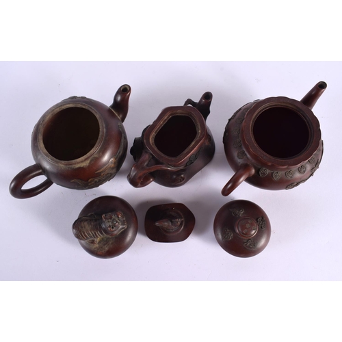 2069 - FIVE CHINESE YIXING POTTERY TEAPOT AND COVERS. Largest 15 cm wide. (5)