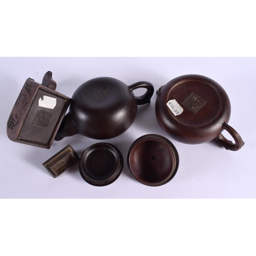 2070 - FIVE CHINESE YIXING POTTERY TEAPOT AND COVERS. Largest 15 cm wide. (5)