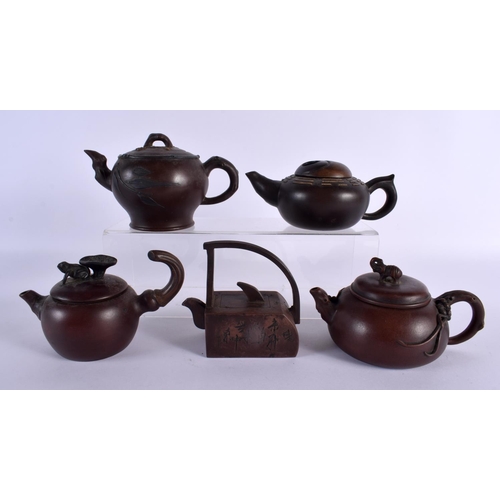 2070 - FIVE CHINESE YIXING POTTERY TEAPOT AND COVERS. Largest 15 cm wide. (5)