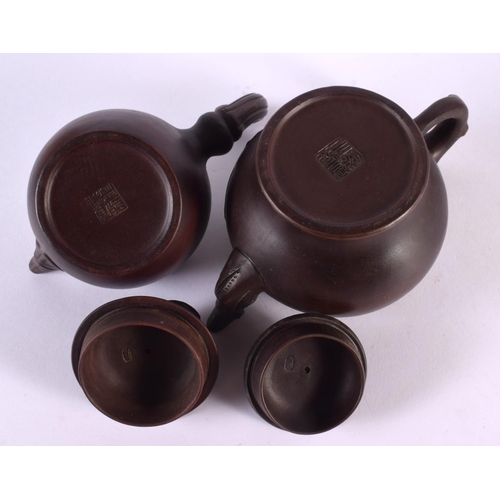 2070 - FIVE CHINESE YIXING POTTERY TEAPOT AND COVERS. Largest 15 cm wide. (5)