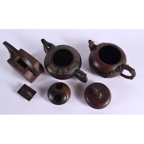 2070 - FIVE CHINESE YIXING POTTERY TEAPOT AND COVERS. Largest 15 cm wide. (5)