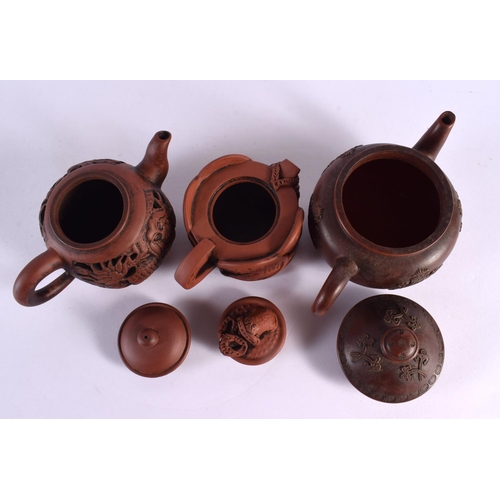 2071 - FIVE CHINESE YIXING POTTERY TEAPOT AND COVERS. Largest 15 cm wide. (5)