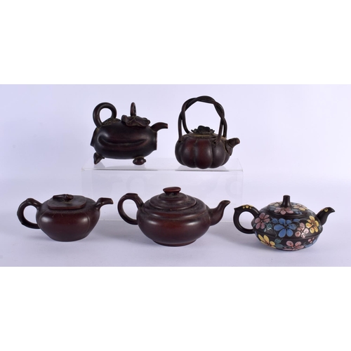 2073 - FIVE CHINESE YIXING POTTERY TEAPOT AND COVERS. Largest 15 cm wide. (5)