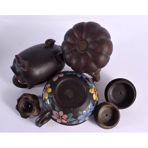 2073 - FIVE CHINESE YIXING POTTERY TEAPOT AND COVERS. Largest 15 cm wide. (5)