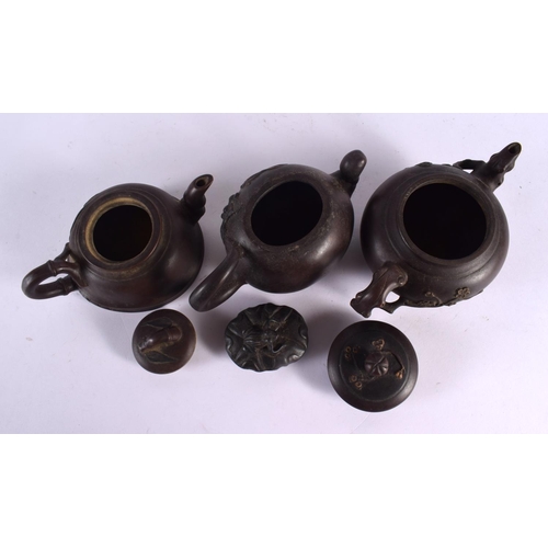 2075 - FIVE CHINESE YIXING POTTERY TEAPOT AND COVERS. Largest 15 cm wide. (5)