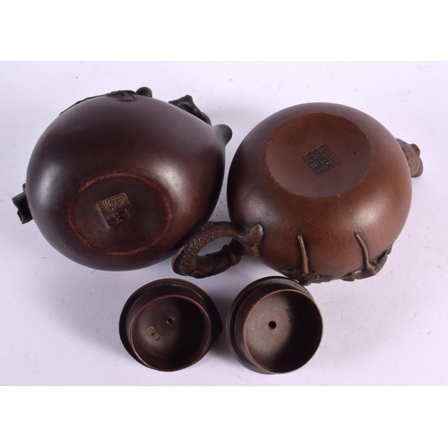 2076 - FIVE CHINESE YIXING POTTERY TEAPOT AND COVERS. Largest 15 cm wide. (5)